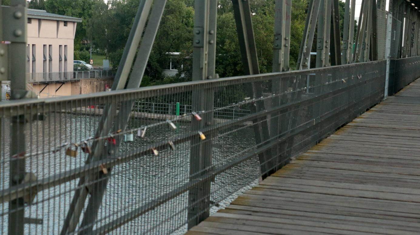 As seen across Europe, couples use the bridge railing to declare their bond of love. They inscribe their names on padlocks, lock them in bridges and throw the keys away.